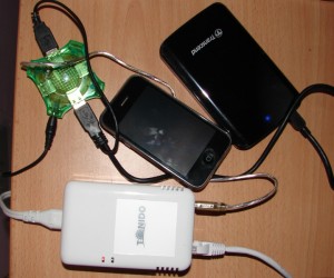 TonidoPlug, an iPhone for size comparison and a Transcend storejet external hard drive connected to the plug via a powered USB hub to prevent hosing the 5W PSU of the plug.